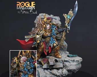May include: A detailed miniature figure of a warrior in gold armor, holding a large ornate blade. The figure stands on a rocky base with a red cape and blue accents. The text "ROGUE MINIATURES" is visible.