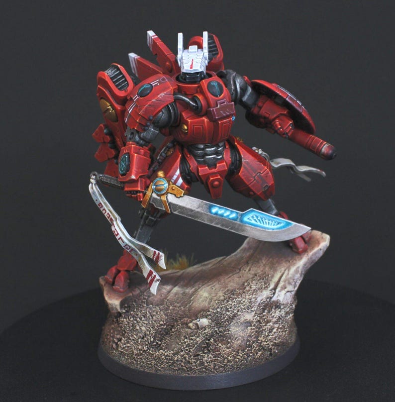 Commander Farsight Warhammer 40k miniature, professionally hand painted in Farsight Enclaves red and white. T'au Empire battlesuit commander, Elite tier display-quality commission painting, fully built, based and varnished.