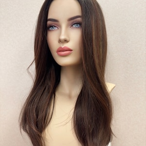 May include: A long, straight, dark brown wig with subtle highlights. The wig is styled with a center part and falls to the shoulders.