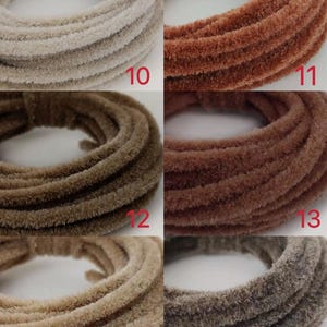 May include: Five spools of chenille stems in various colours, including beige, brown, and rust. The spools are labelled with numbers 10, 11, 12, 13, 14, and 15.