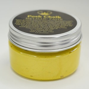 May include: A small jar of yellow metallic paint labeled "Posh Chalk Metal Paste". The label also includes the company's website and phone number. The jar is 110 ml and UV protected.