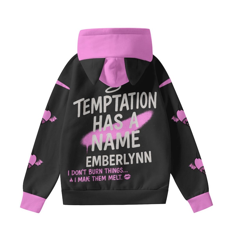 May include: Black hoodie with pink accents, featuring the text "TEMPTATION HAS A NAME EMBERLYNN". The hoodie has a pink hood and cuffs, with bat-wing designs on the sleeves. The text "I DON'T BURN THINGS... I MAKE THEM MELT" is also printed on the hoodie.
