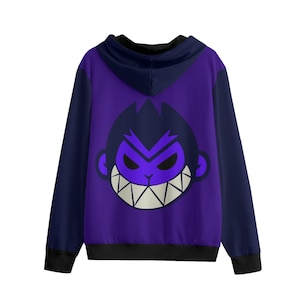 Op de afbeelding: Een paarse hoodie met ritssluiting en marineblauwe mouwen en capuchon. De achterkant toont een cartoon apengezicht met paarse ogen en een brede, tandige grijns. De zoom en manchetten zijn zwart.