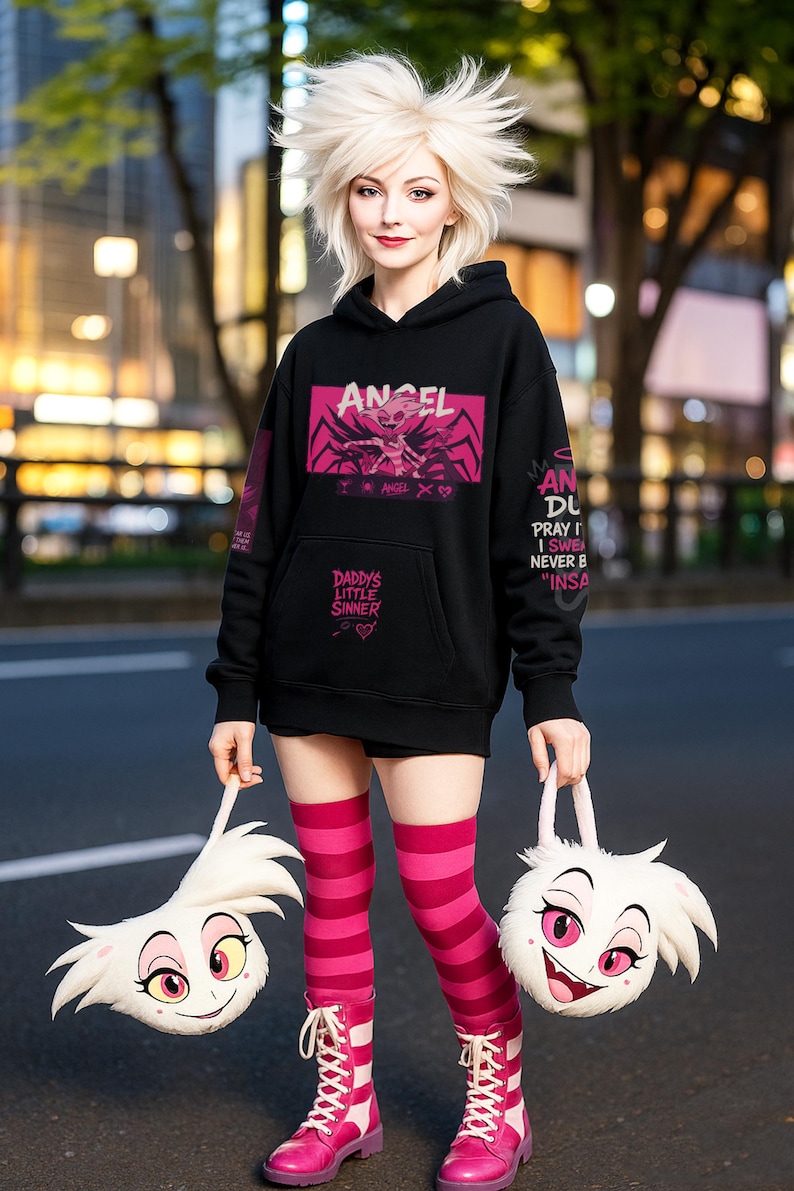 May include: Black hoodie with pink graphic text and design. The text includes "ANGEL" and "DADDY'S LITTLE SINNER". The person is wearing pink and white striped knee-high socks and pink boots. Two white plush bags with cartoon faces are held.