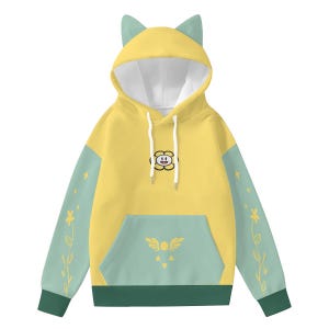 May include: Yellow hoodie with cat ears, a white drawstring, and a front pocket. The sleeves are light green with floral and star designs. A flower graphic is on the chest. The cuffs and bottom hem are dark green.