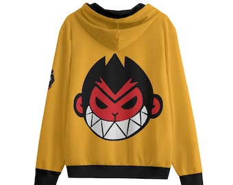 Può includere: Felpa con cappuccio giallo senape con una grande faccia di scimmia dei cartoni animati sul retro. La scimmia ha una faccia rossa, capelli neri e denti bianchi. La felpa ha finiture nere sui polsini e sull'orlo inferiore.