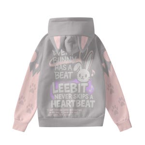 May include: A gray hoodie with pink accents and bunny ear details on the hood. The sleeves are pink with paw prints. The back features a graphic of a bunny and text that reads "WE BUNNY HAS A BEAT LEEBIT NEVER SKIPS A HEARTBEAT".