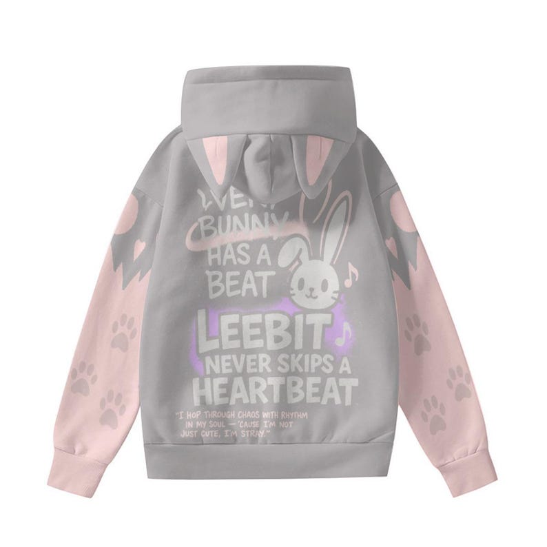 May include: A gray hoodie with pink accents and bunny ear details on the hood. The sleeves are pink with paw prints. The back features a graphic of a bunny and text that reads "WE BUNNY HAS A BEAT LEEBIT NEVER SKIPS A HEARTBEAT".