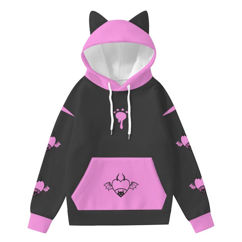 May include: Black hoodie with a pink cat ear hood, pink accents, and a front pocket. The hoodie features a paw print design and bat-winged heart graphics. The sleeves have bat-winged heart designs. The hoodie is made of a soft material.