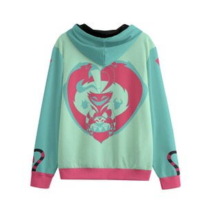 May include: A teal hoodie with a pink and teal heart-shaped graphic on the back. The graphic features a cartoon character. The sleeves are teal with pink cuffs and a black and pink design near the wrist. The hood is teal with a black lining.