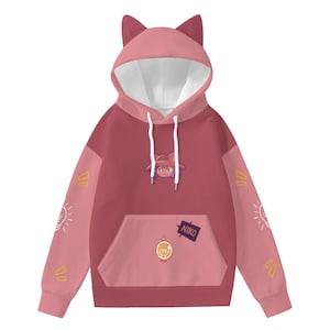 May include: A pink and maroon hooded sweatshirt with cat ears on the hood. The sweatshirt features a front pocket and a graphic of a cat-like character. The sleeves have light bulb and triangle designs. The word "NIKO" is on a patch.