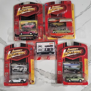 May include: A collection of five Johnny Lightning die-cast toy cars in various colors, including red, green, white, and black. The cars are all muscle cars from the 1960s and 1970s. Each car is packaged in a blister pack with a clear plastic window.