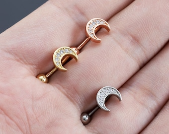 May include: Three crescent moon shaped body jewelry pieces with clear rhinestones. The jewelry is made of surgical steel and comes in gold, rose gold, and silver.