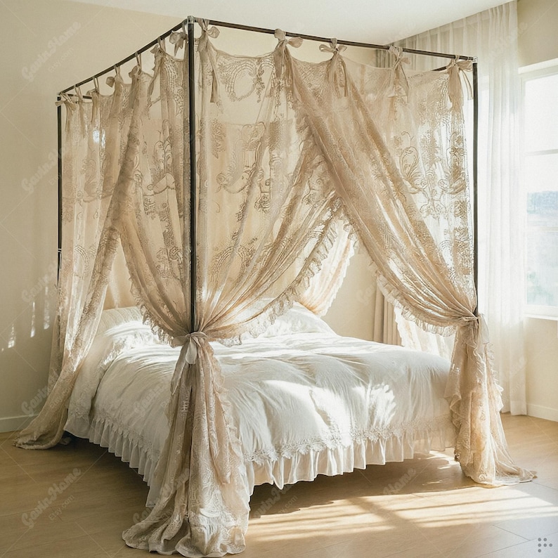 May include: A four-poster bed with a metal frame and draped with sheer, beige lace curtains. The bed is made with white bedding, including a ruffled bed skirt. The curtains are tied back at the posts.