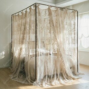 May include: A beige canopy bed with sheer, embroidered curtains. The curtains are draped around a dark metal frame, creating an elegant and airy aesthetic. The bed is made with matching bedding, creating a cohesive and inviting bedroom setting.