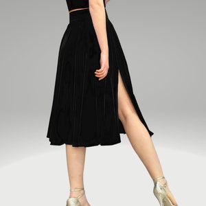 May include: A black velvet midi skirt with a side slit and pleats. The skirt is knee-length and has a high waist.
