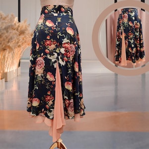 May include: A dark blue and peach floral skirt with a high waist and a flowing, asymmetrical hemline. The skirt has a peach underlayer that peeks out from the bottom.