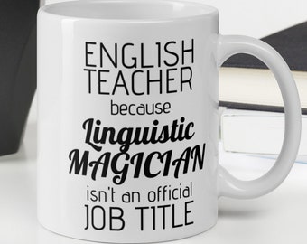 May include: White ceramic mug with black text that reads "English Teacher because Linguistic Magician isn't an official job title."