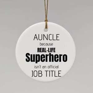 Puede incluir: Adorno de cerámica blanca con texto negro que dice "AUNCLE because REAL-LIFE Superhero isn't an official JOB TITLE".