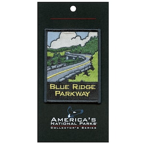 May include: A blue and green embroidered patch with a winding road and a yellow line down the center. The text "BLUE RIDGE PARKWAY" is in yellow letters on a black background. The patch is part of the "America's National Parks Collector's Series."