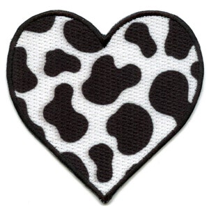 May include: A white heart-shaped patch with a black cow print pattern.