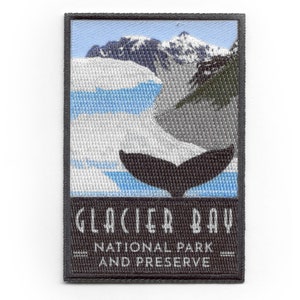 May include: A black and white embroidered patch with a blue and white image of a glacier and a whale tail. The text "Glacier Bay National Park and Preserve" is printed in white on a black background.