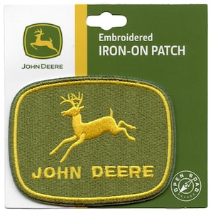 May include: Embroidered iron-on patch featuring the John Deere logo. The logo is green with a yellow deer and the words "John Deere" in yellow.