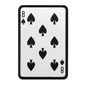 May include: A white playing card with a black border. The card is an eight of spades. The suit is displayed eight times on the card in a diamond pattern.