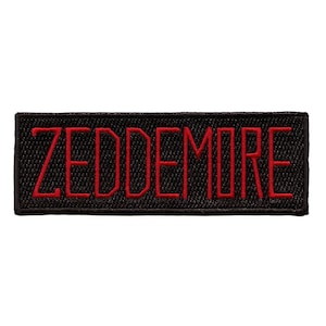 May include: Black fabric patch with the word "ZEDDEMORE" embroidered in red.