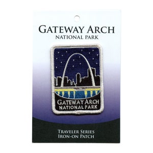 May include: A rectangular iron-on patch featuring the Gateway Arch against a starry night sky. The patch includes the text "Gateway Arch National Park" and "Traveler Series Iron-On Patch". The design is bordered by a silver-gray trim.