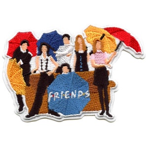 May include: Embroidered patch featuring the six main characters from the TV show "Friends" standing in front of a couch with an umbrella behind each of them. The word "FRIENDS" is written in blue on a blue umbrella in the center of the patch.