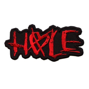 May include: Red embroidered patch with the word "HATE" in a stylized font on a black background.