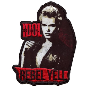 May include: A black and red embroidered patch featuring a portrait of Billy Idol with the text "Billy Idol" and "Rebel Yell" in red.