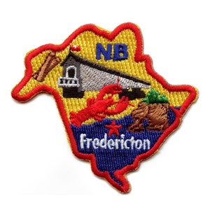 May include: A yellow, red and blue embroidered patch shaped like the province of New Brunswick, Canada. The patch features a lobster, a building, and the text "NB" and "Fredericton".