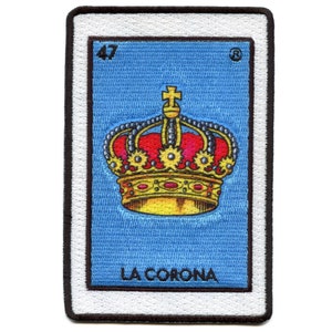 May include: A vintage-style Loteria card with a blue background and a gold crown with red jewels. The card is numbered 47 and the text "LA CORONA" is printed below the crown.