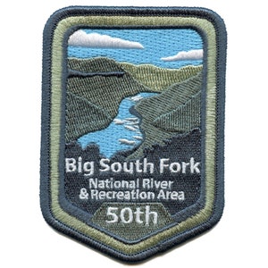 May include: An embroidered patch in green, blue and white with the text "Big South Fork National River & Recreation Area 50th". The patch features a stylised image of a river flowing through a valley.