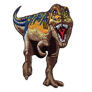 May include: Embroidered patch of a brown, yellow, and blue Tyrannosaurus Rex dinosaur with a red open mouth and white teeth.