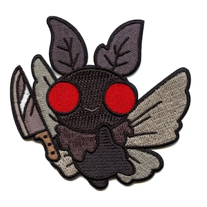 May include: Embroidered iron-on patch of a black moth with red eyes holding a knife. The moth has brown wings with a light brown pattern.