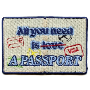 May include: Embroidered patch with a passport theme. It says "All you need is love... A PASSPORT" with a red line through "love".
