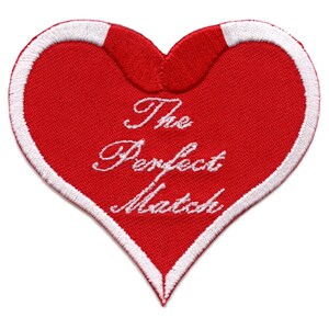 May include: Red heart-shaped patch with white embroidered outline and the text "The Perfect Match" in white cursive lettering.