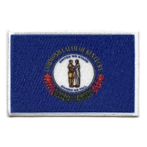 May include: A blue patch with a white border featuring the state seal of Kentucky. The seal depicts two figures shaking hands with the text "United We Stand, Divided We Fall" and "Commonwealth of Kentucky".