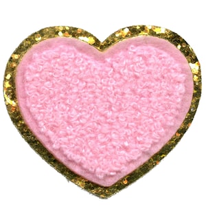 May include: Pink heart-shaped patch with a gold glitter trim. The heart is made of a fuzzy material.