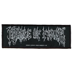 May include: Black woven patch with white embroidered text that reads "Temple of  the  Frow", with the text "Under license from Omerch Ltd" below.