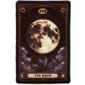 May include: A tarot card with a dark brown background and gold accents. The card depicts a full moon with a dark, textured surface. The card number XVIII and the words "THE MOON" are printed in gold at the top and bottom of the card.
