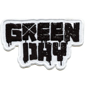 May include: Black and white embroidered patch with the text "GREEN DAY" in a dripping font style.