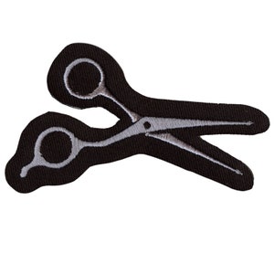 May include: Black fabric patch with a white embroidered image of a pair of scissors.