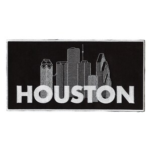 Może przedstawiać: Czarno-biała naszywka haftowana z panoramą Houston w Teksasie i napisem "HOUSTON" białymi literami.