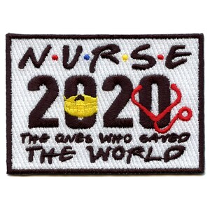 May include: White embroidered patch with black text that reads "N.U.R.S.E. 2020 The ones who saved THE WORLD" with a yellow face mask and a red stethoscope.