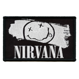 May include: Black and white embroidered patch featuring a white smiley face with an 'X' for eyes and the word 'NIRVANA' in white lettering.