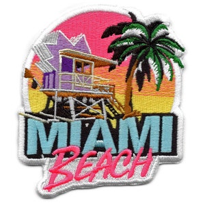 May include: An embroidered patch featuring a colourful sunset scene, a purple lifeguard stand, a palm tree, and the text "Miami Beach".